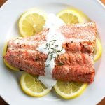 overhead photo of grilled salmon topped with cream sauce