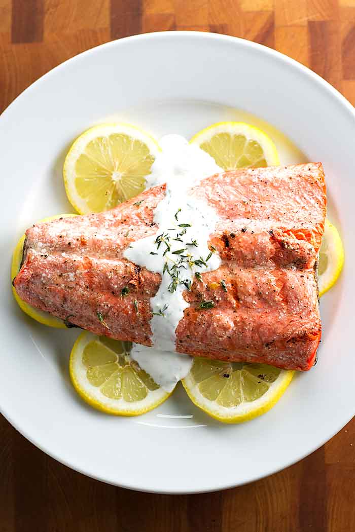 overhead photo of grilled salmon topped with cream sauce