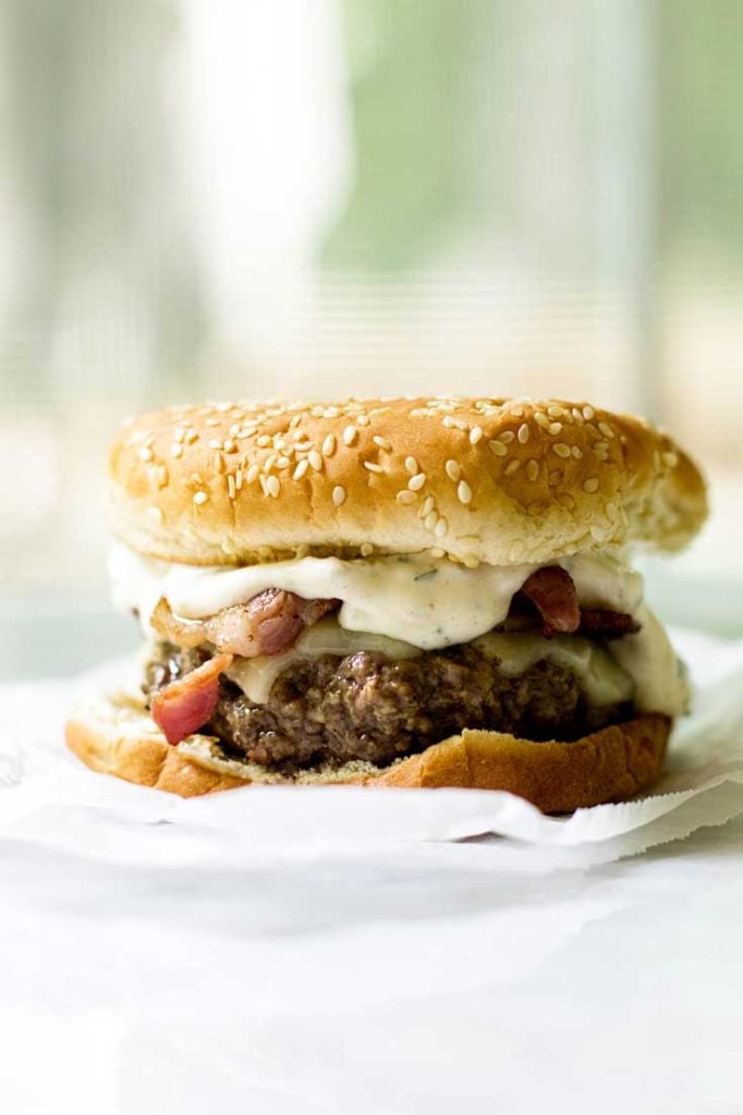 Bacon cheeseburgers dressed up with creamy green chile mayo