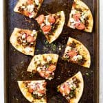 Slices of chorizo and goat cheese pita pizza