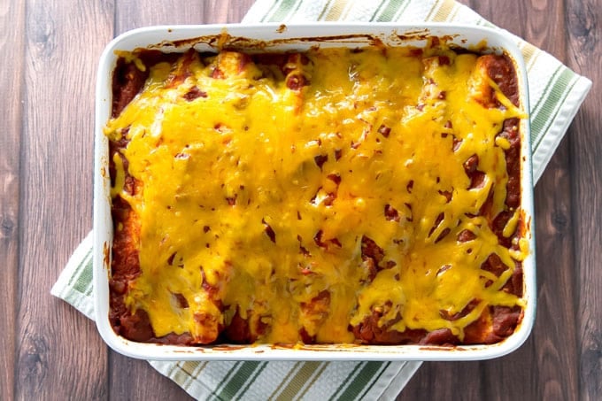 overhead photo of a a baking dish with chicken enchiladas