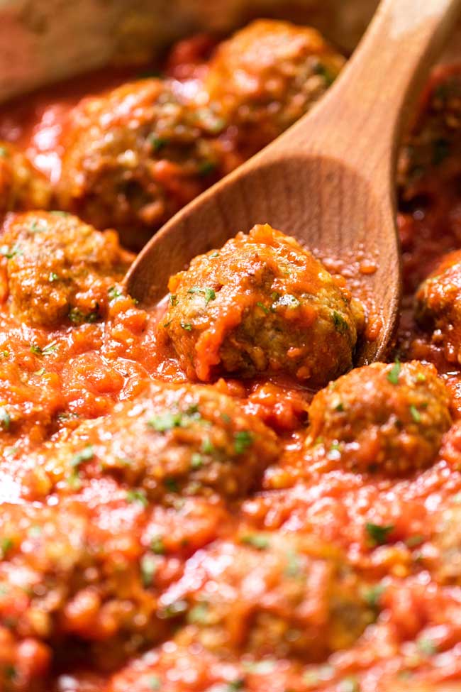 Close-up photo of a meatball in sauce