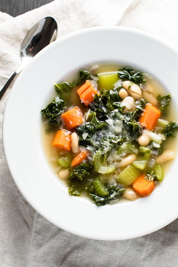 hearty veggie soup in a white bowl