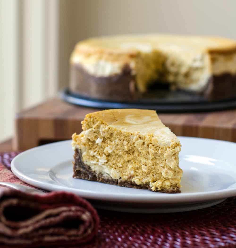 A slice of pumpkin cheesecake on a plate