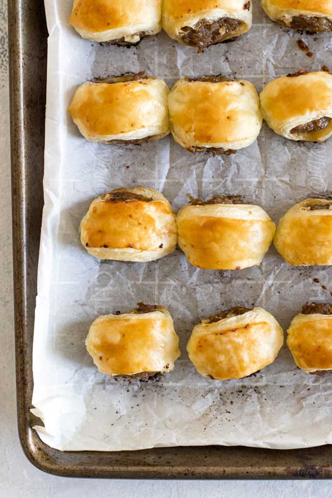 overhead photo of pork sausage rolls on a baking sheet