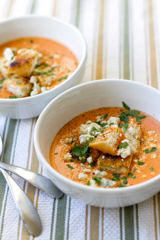 Roasted red pepper tomato bisque in a white bowl