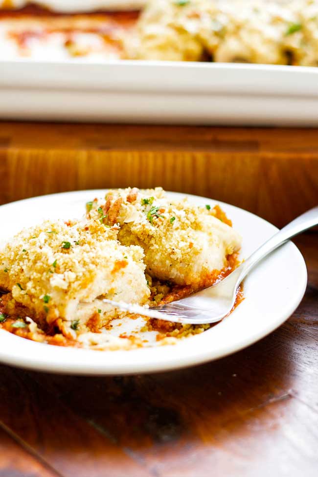 Baked chicken roll-ups on a plate with a fork