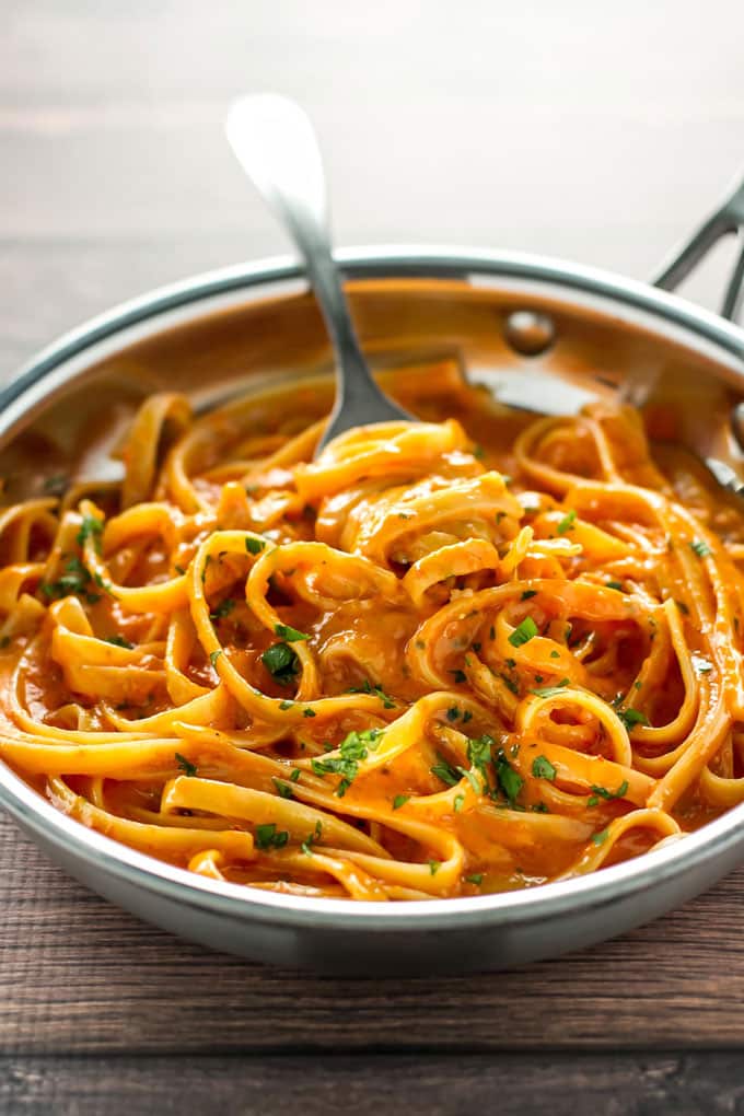 Roasted red pepper alfredo in a skillet with a fork