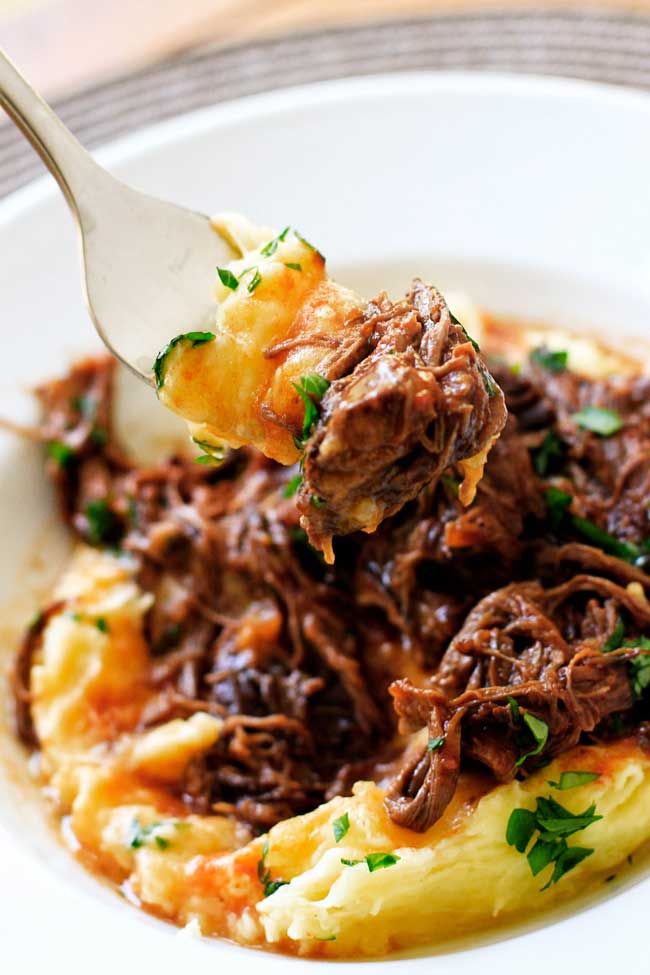 A forkful of short rib ragu with parmesan mashed potatoes