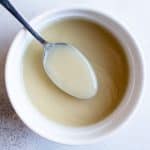 photo of a bowl of veloute sauce with a spoon