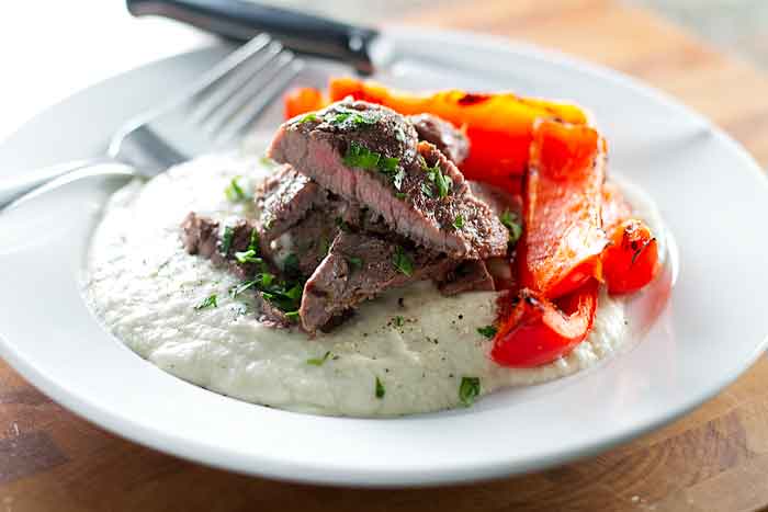 Grilled steak on eggplant puree with red peppers