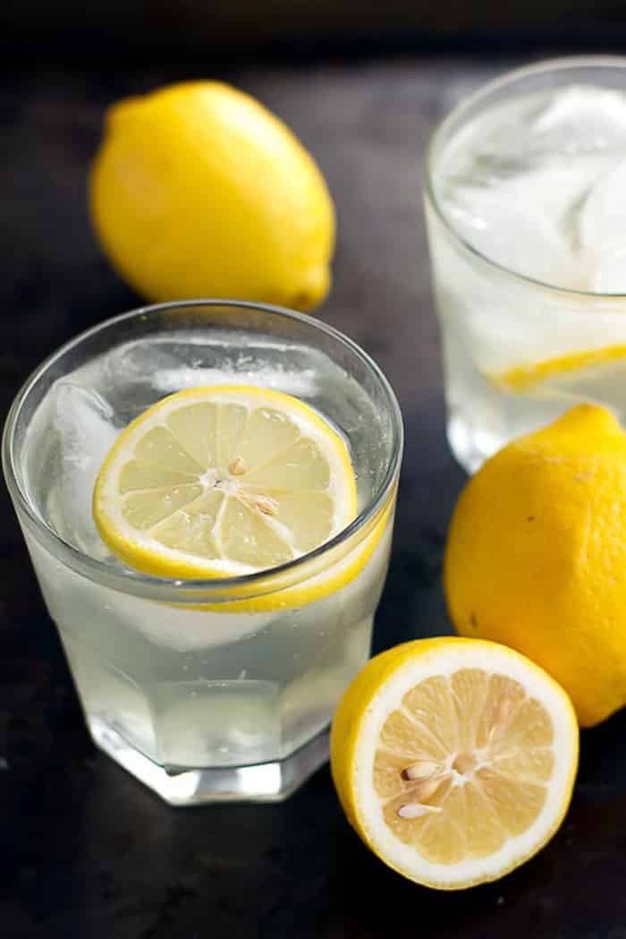 A glass of citrus cooler with a lemon slice