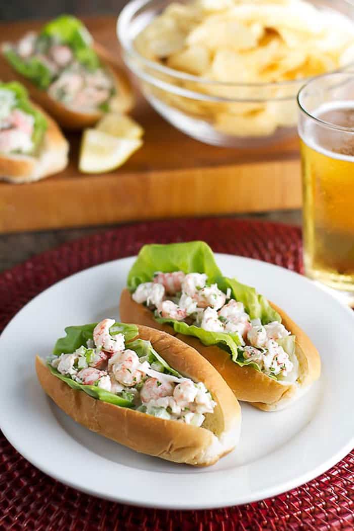 two lobster salad sandwiches on a white plate