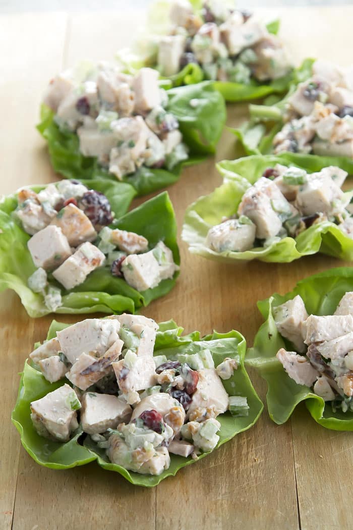 chicken salad lettuce wraps lined up on a cutting board