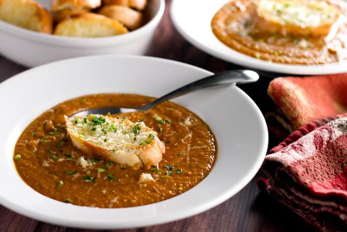 a bowl of chickpea soup with a crostini.