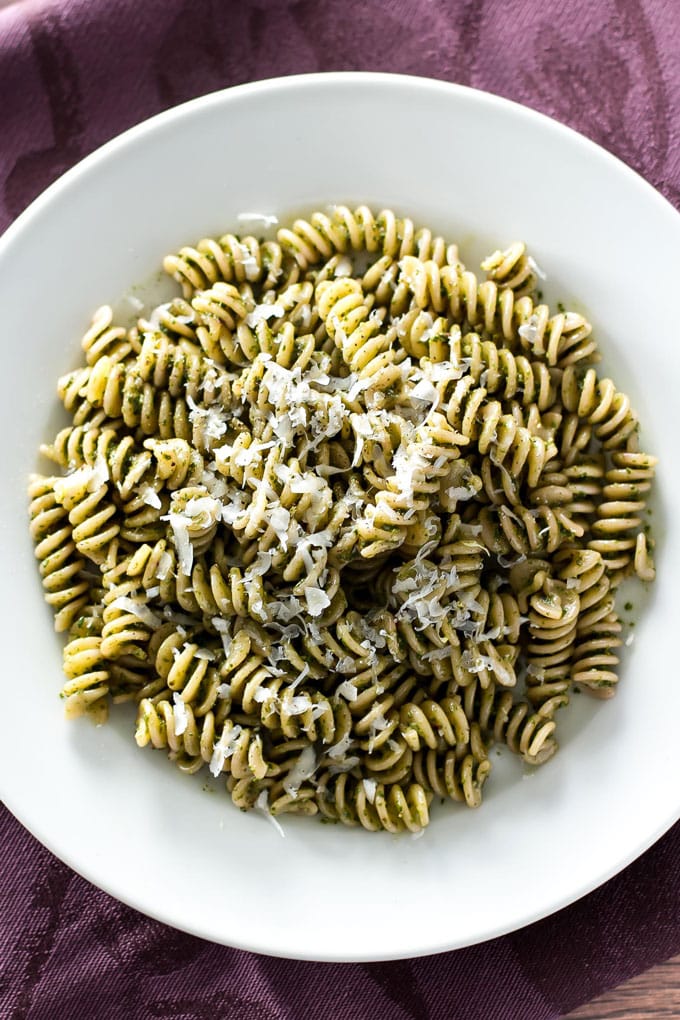 beet tops pesto with pasta in a white bowl