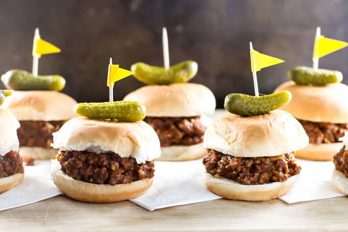 mini sloppy joe sandwiches lined up on a cutting board