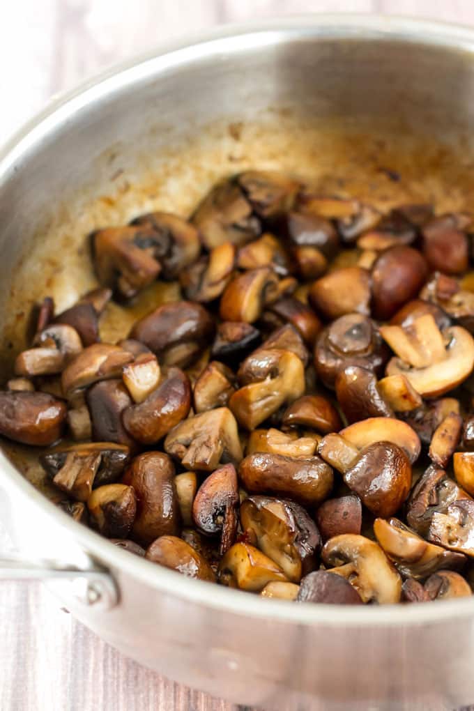 A skillet with cooked mushrooms