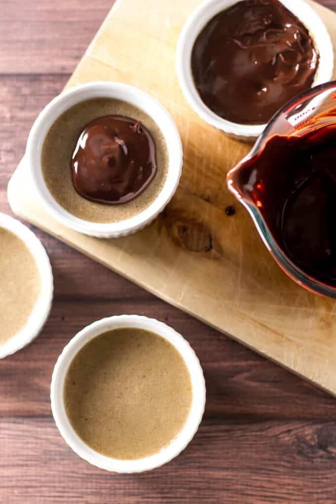 overhead photo of chocolate ganache being added to pots de creme