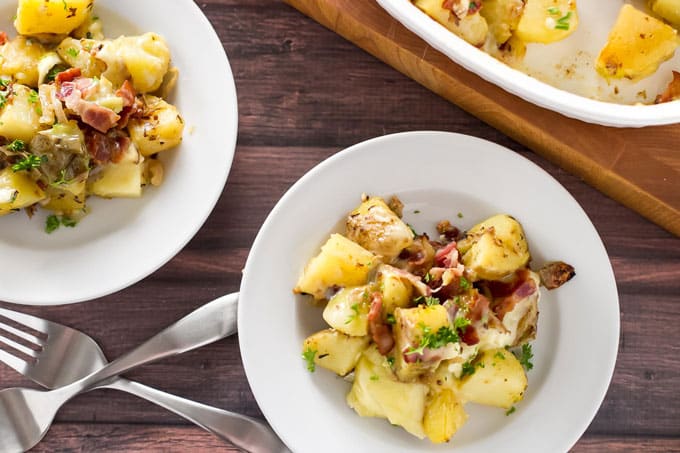 Tartiflette on white plates with forks