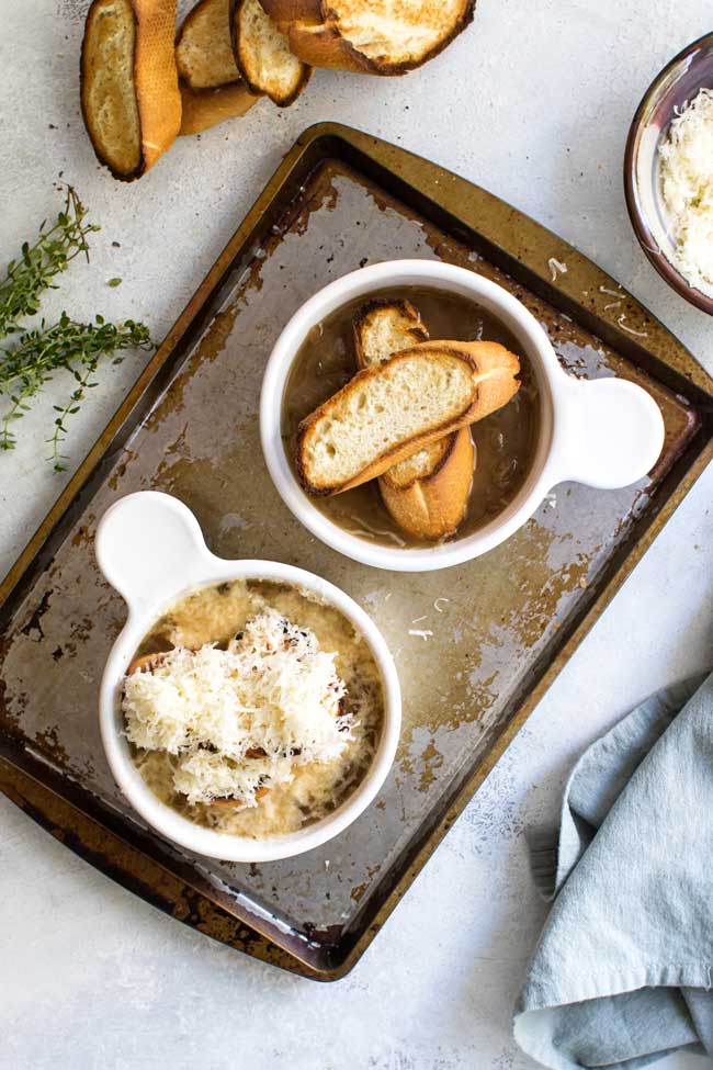 overhead photo of bowls of french onion soup being assembled