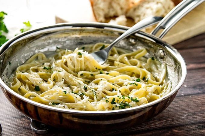 Fettuccine in a skillet with a fork