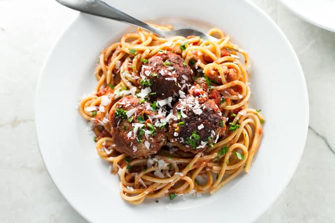 Spaghetti and meatballs on a white plate