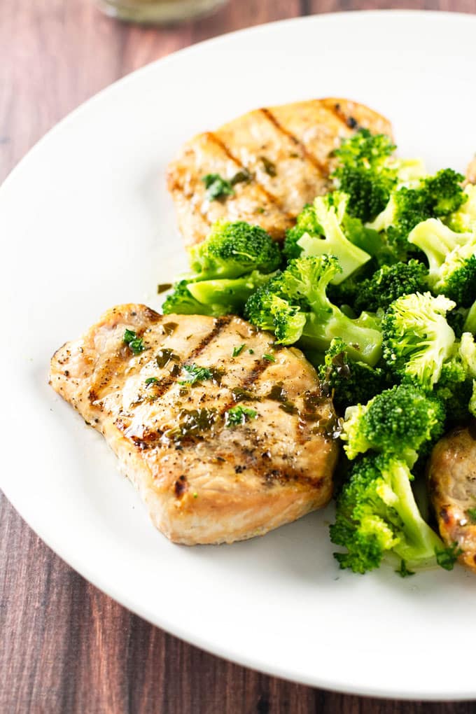 cedar plank pork chops on a plate with broccoli