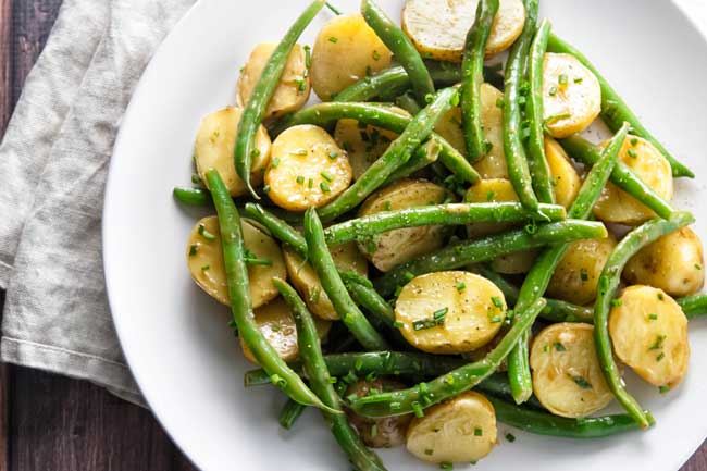 Green bean potato salad on a white plate