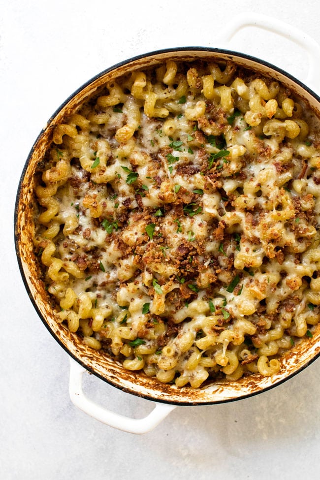 Overhead shot of mushroom macaroni and cheese in a white oven-safe pan