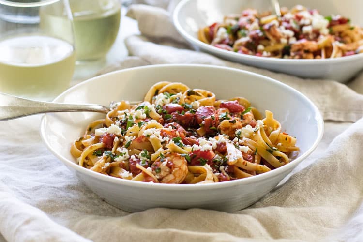 Photo of a bowl with shrimp fettuccine with tomatoes and feta