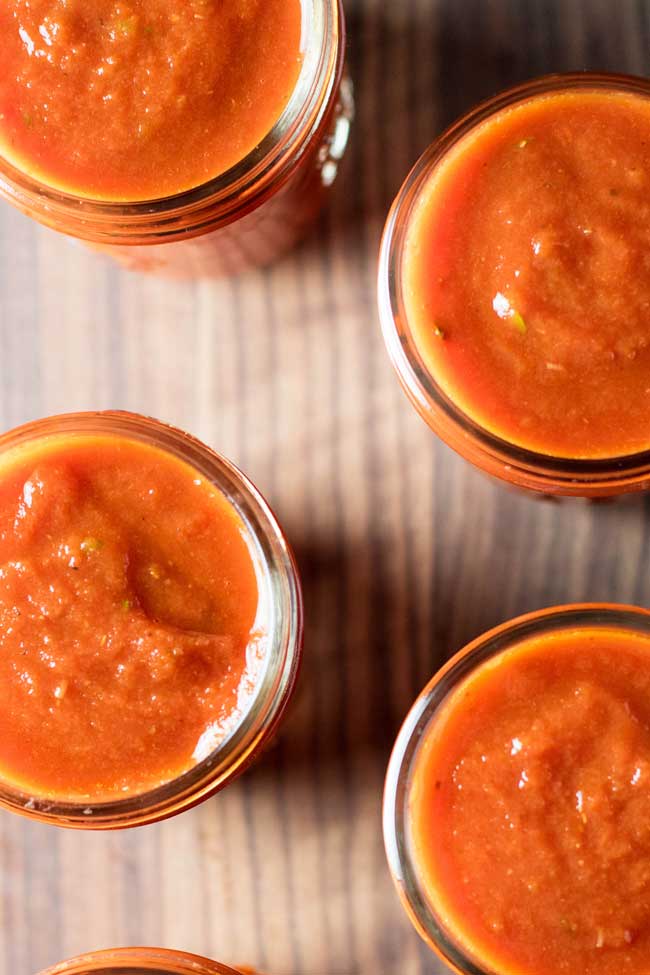 overhead photo of jars filled with tomato sauce