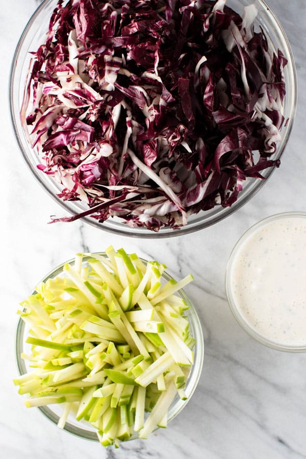 Ingredients for slaw: raddichio, apples, and dressing