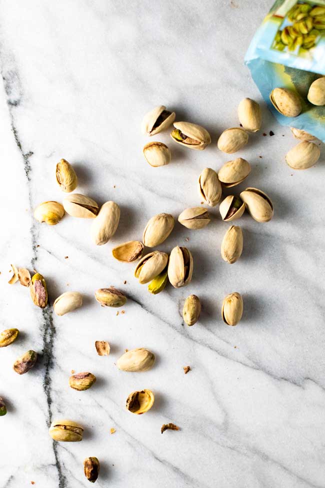 shelled pistachios on a marble board