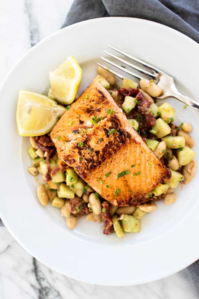 overhead photo of a plate with salmon and salad