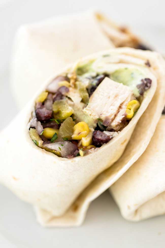 Southwest Chicken Wraps with black beans, green chile, and an avocado ranch dressing | girlgonegourmet.com