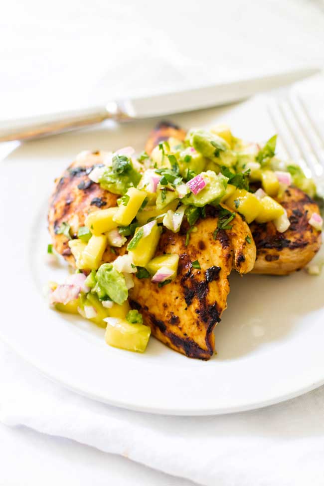 photo of grilled chicken topped with mango salsa