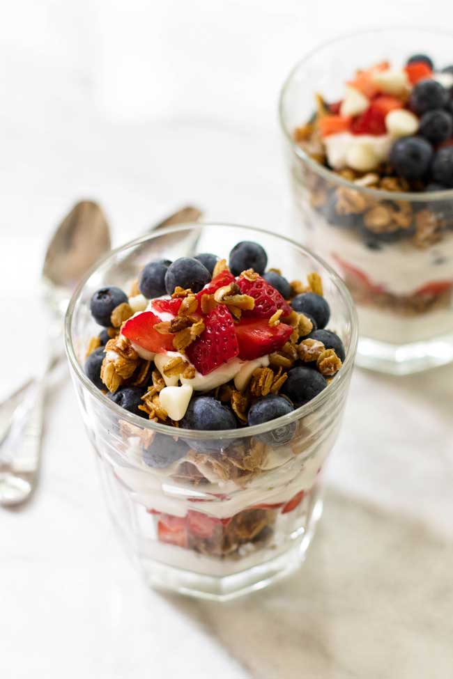 Breakfast parfaits with homemade white chocolate granola, fresh fruit, and Greek yogurt