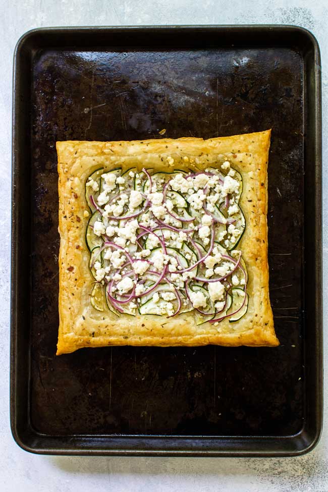 zucchini and goat cheese puff pastry on a baking sheet