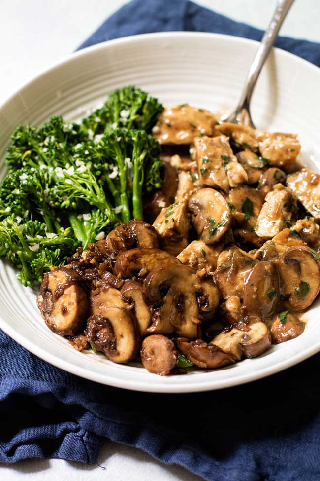 photo of a bowl of One-Pan Mushroom Chicken with steam broccolini