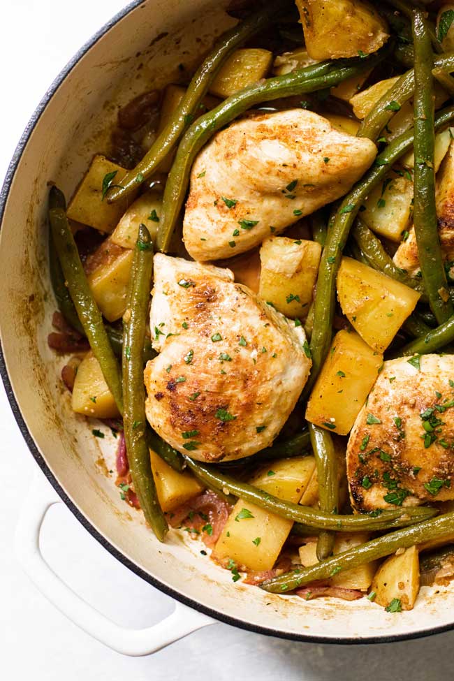 overhead photo of chicken with green beans and potatoes in a pan