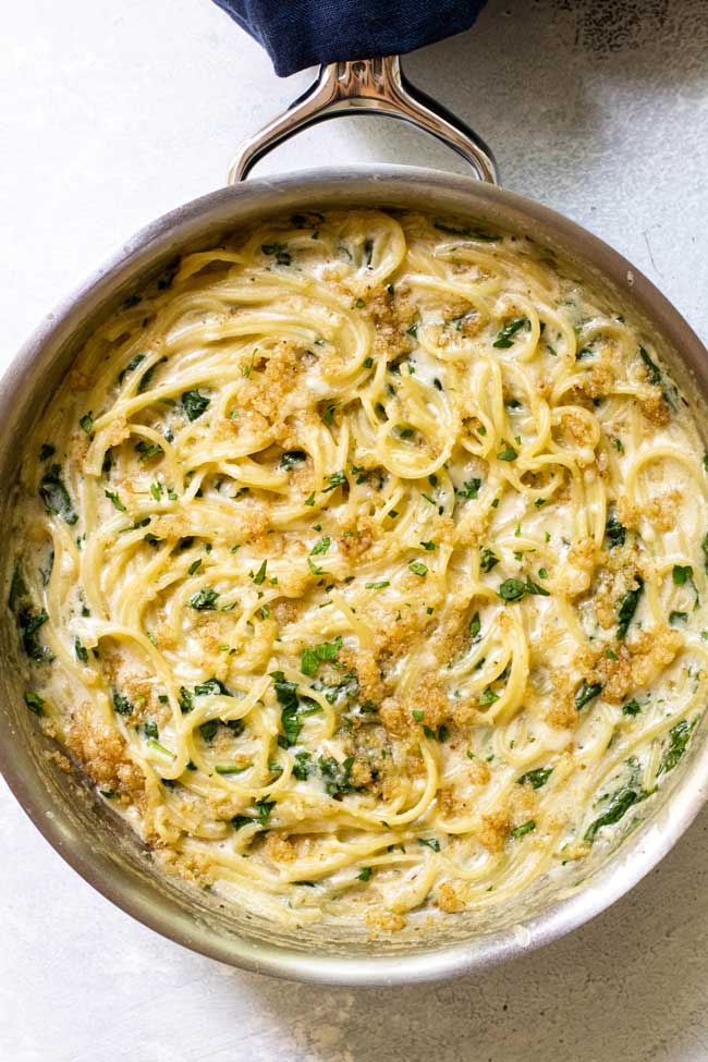 overhead shot of creamy gruyere spaghetti in a skillet