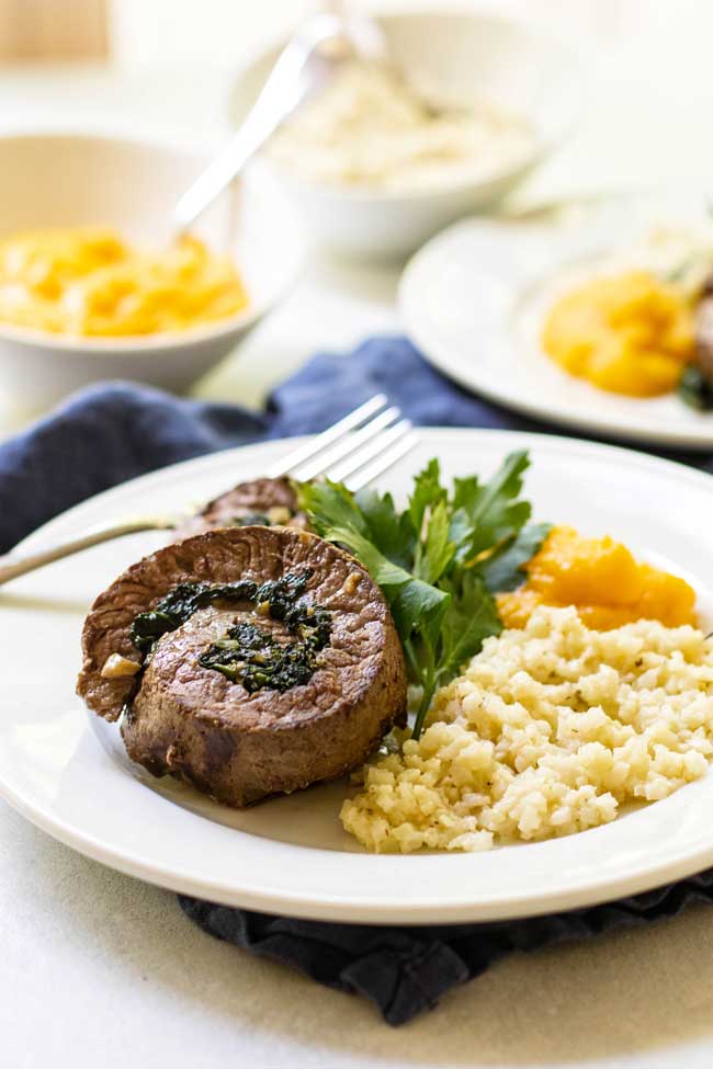 Beef roll-up filled with spinach and sage on a plate with Alexia cauliflower risotto and mashed butternut squash