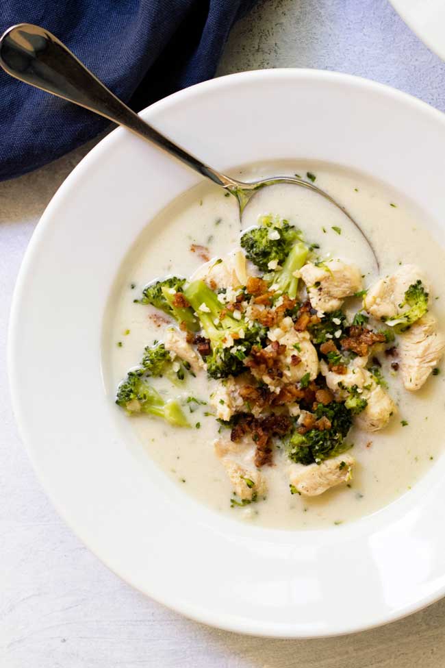 Broccoli Chicken Soup for two garnished with crispy bacon and Parmesan cheese