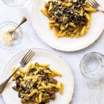 One-pot pasta with sausage and arugula on two plates