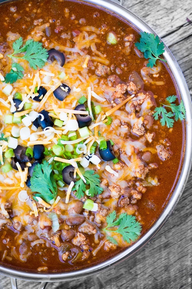 A big bowl of meat lovers chili topped with cheese