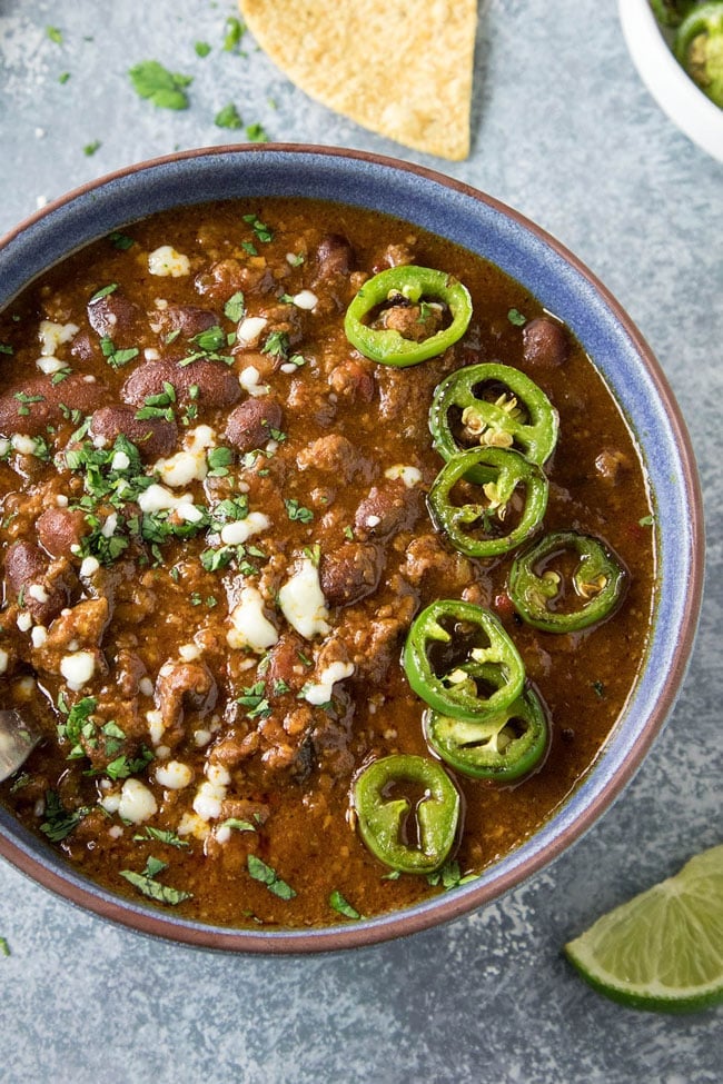 A bowl of southwest beef chili topped with sliced jalapeno peppers