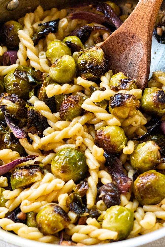 Roasted brussels sprouts, red onion, and garlic in a large skillet with gemelli pasta, lemon juice, and grated parmesan.