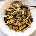 One serving of roasted vegetable pasta in a white bowl