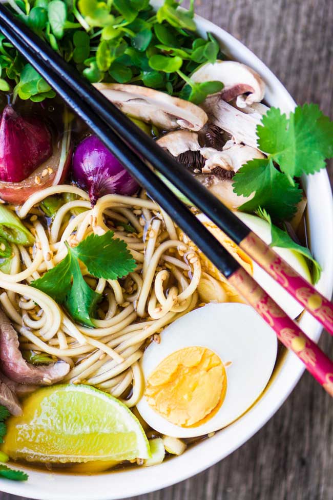 Slow Cooker Pho in a bowl with chopsticks